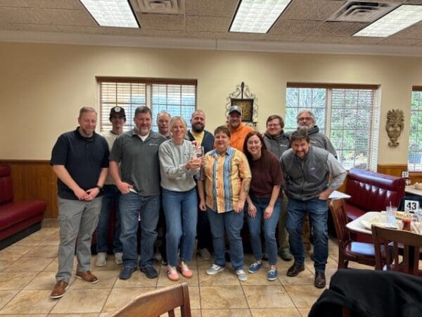 WithersRavenel employees stand with an award.