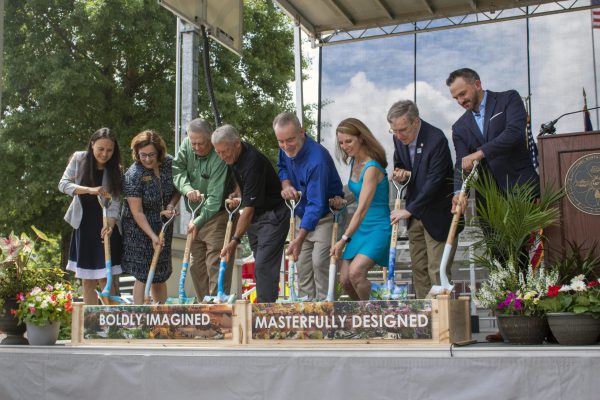 Town of Cary staff symbolically breaking ground using painted shovels at Downtown Cary park site
