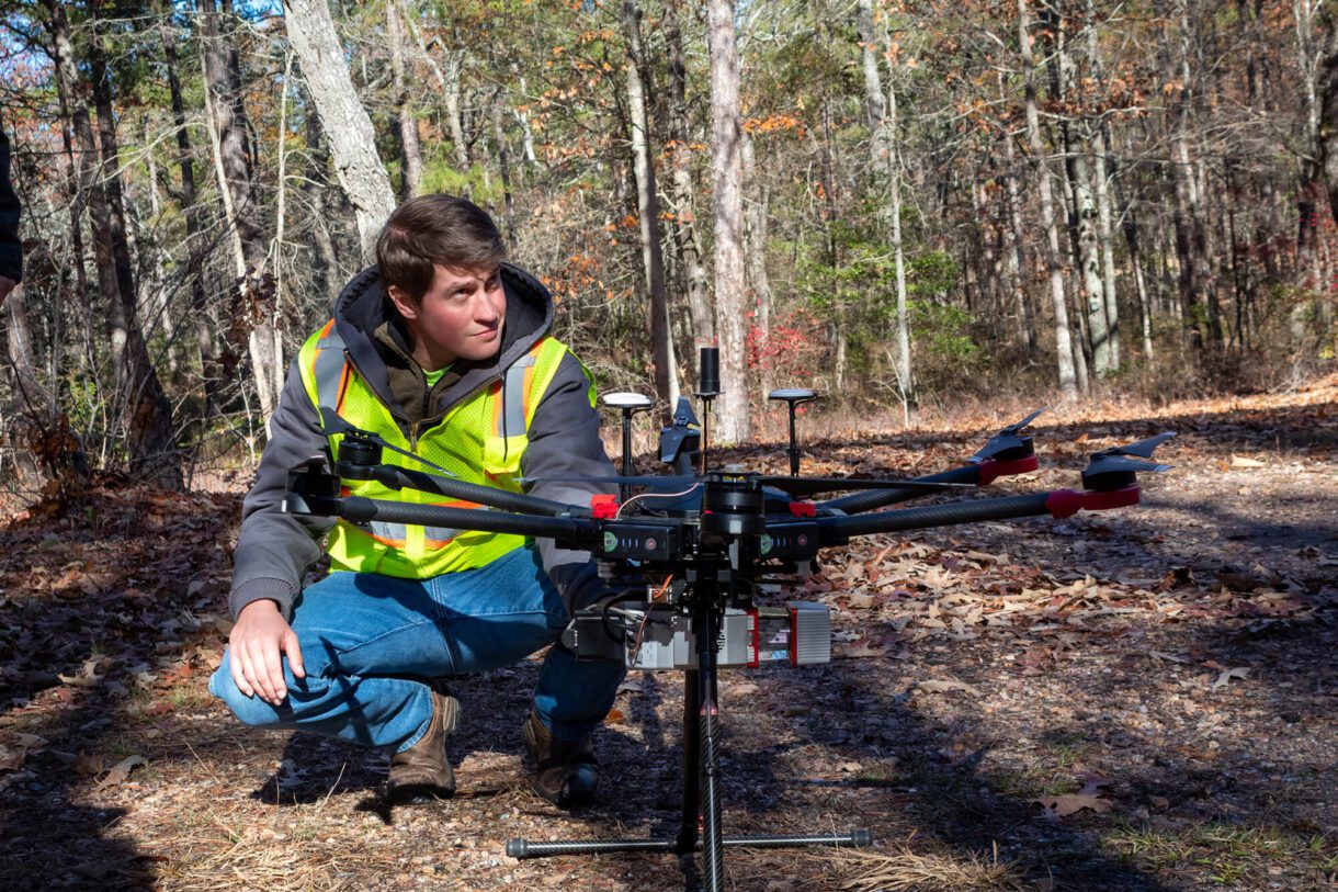 a worker preparing a drone for surveying