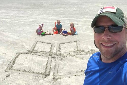 the WithersRavenel icon drawn in sand at the beach
