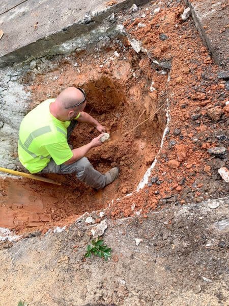 a worker digging in a hole