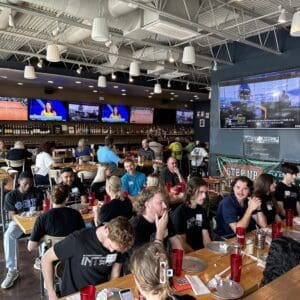 Group of young professionals at a restaurant having pizza lunch