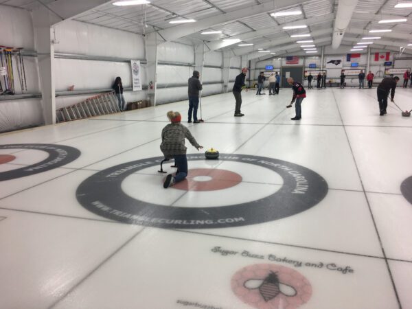 Company teambuilding activity at a curling rink