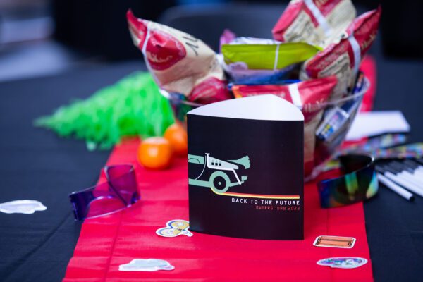 A table centerpiece with paper trifold display, snacks, and noisemakers