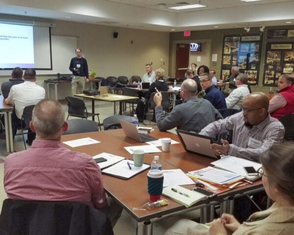 large group of employees learning at an event