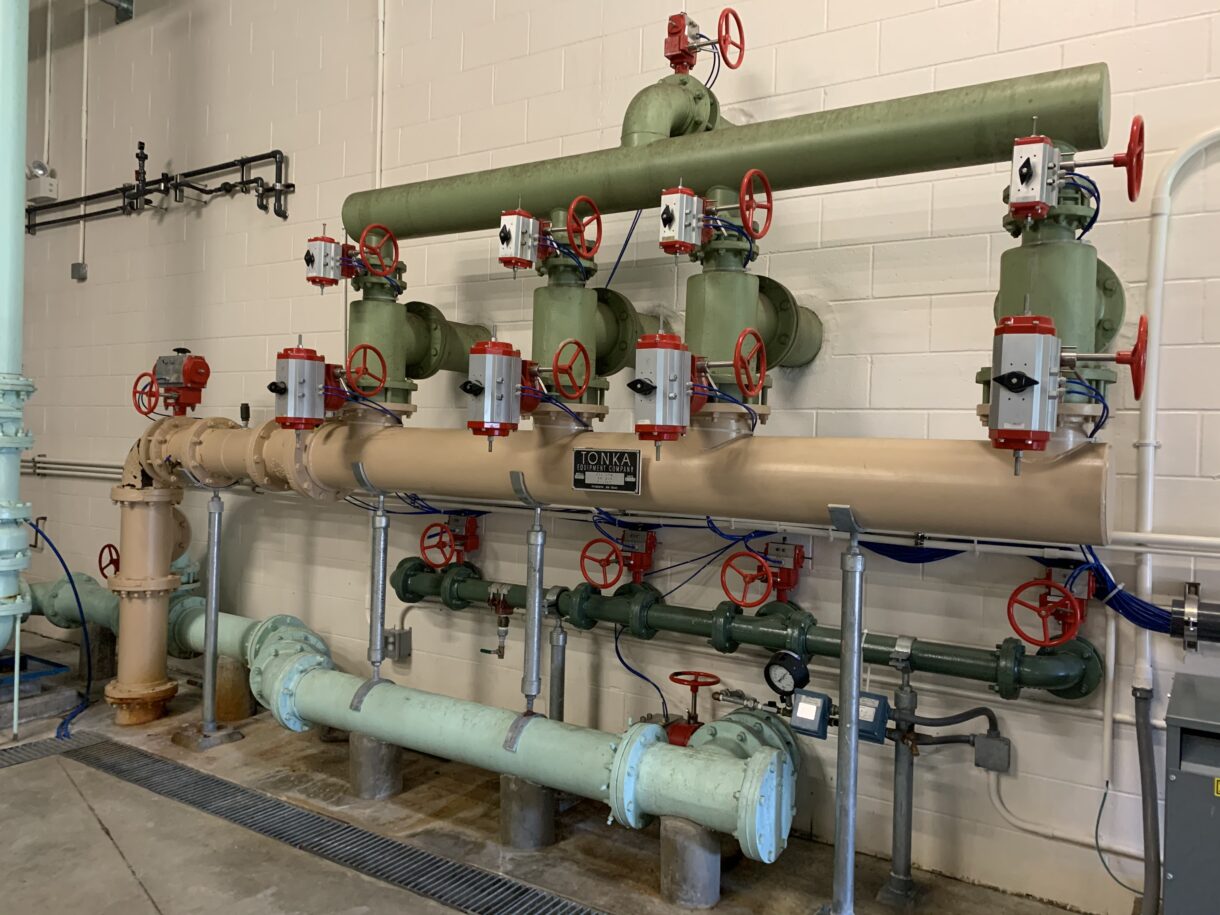 Pipes and gauges lining the inside of a water treatment facility.