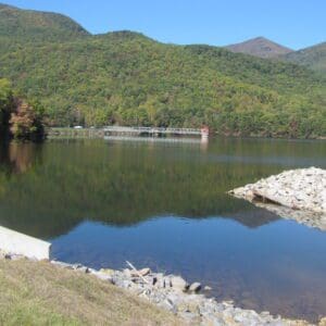 A picture looking across a lake at a newly completed dam.