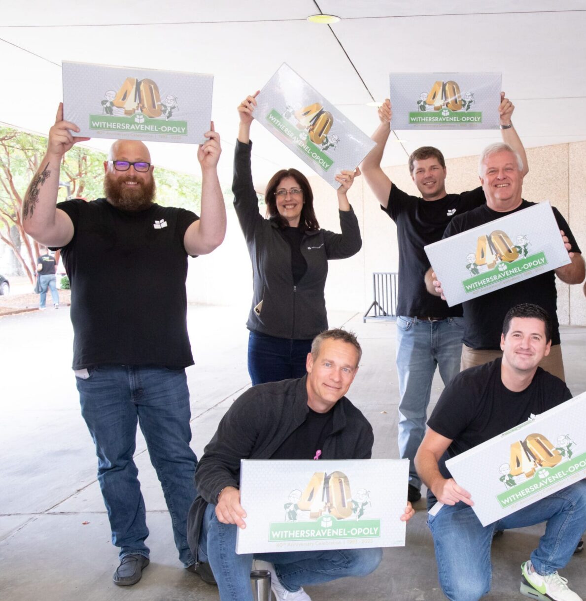A group of WithersRavenel employees holding a board game