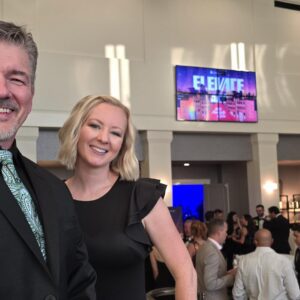 Two formally dressed professionals at an awards banquet.