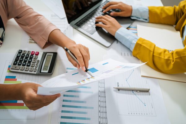 Accountant pointing at data points on a paper.