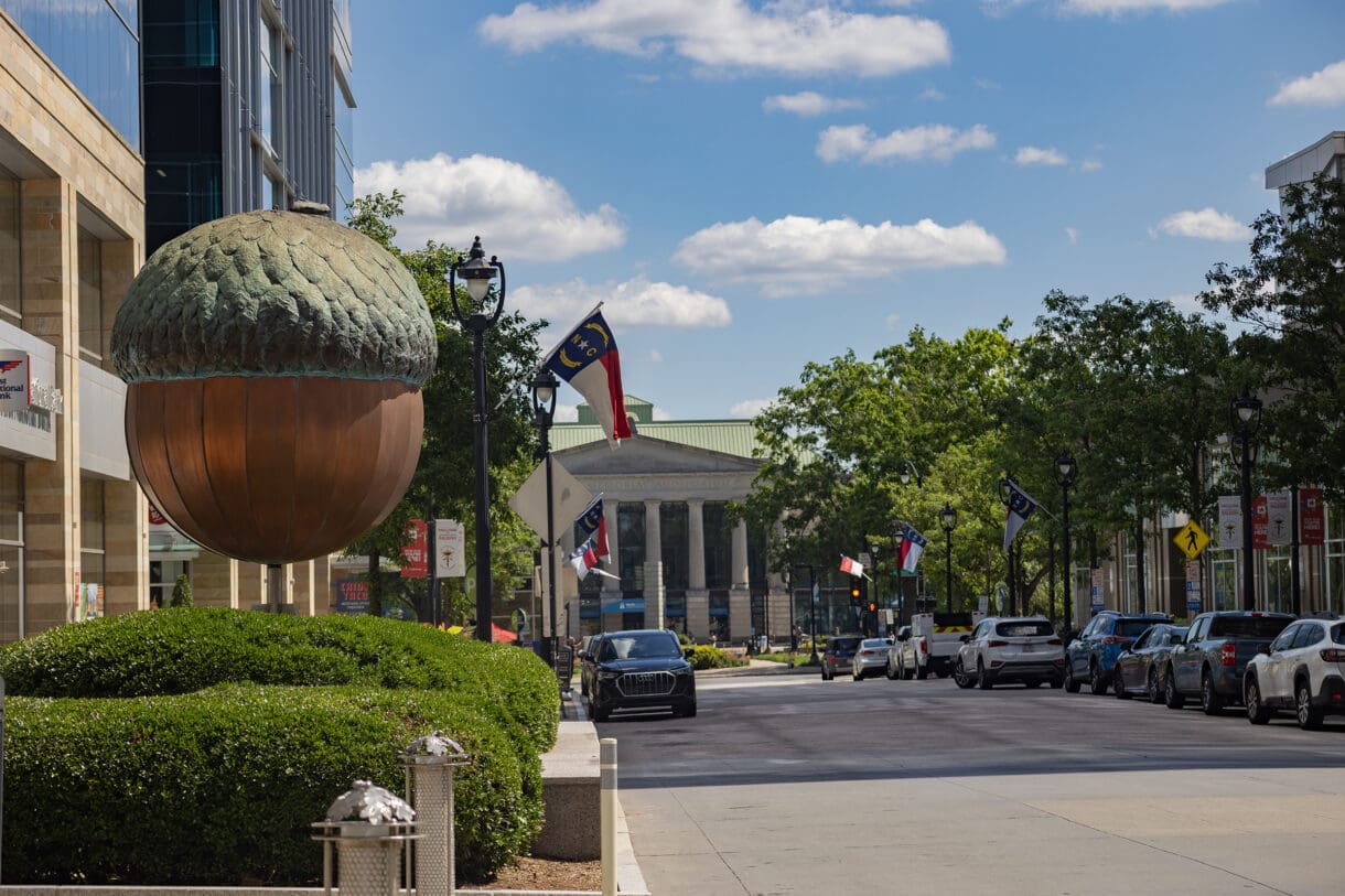 A sidewalk perspective of the street leading to the North Carolina state capital in Raleigh.