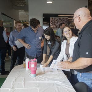 Company employees mingle at Ownership Month event.