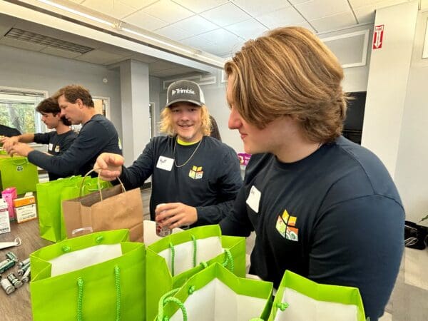 A man in a WithersRavenel hat assembles thank you bags for first responders