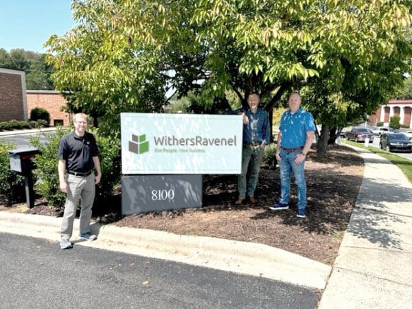 Charlotte field office sign with staff standing next to it