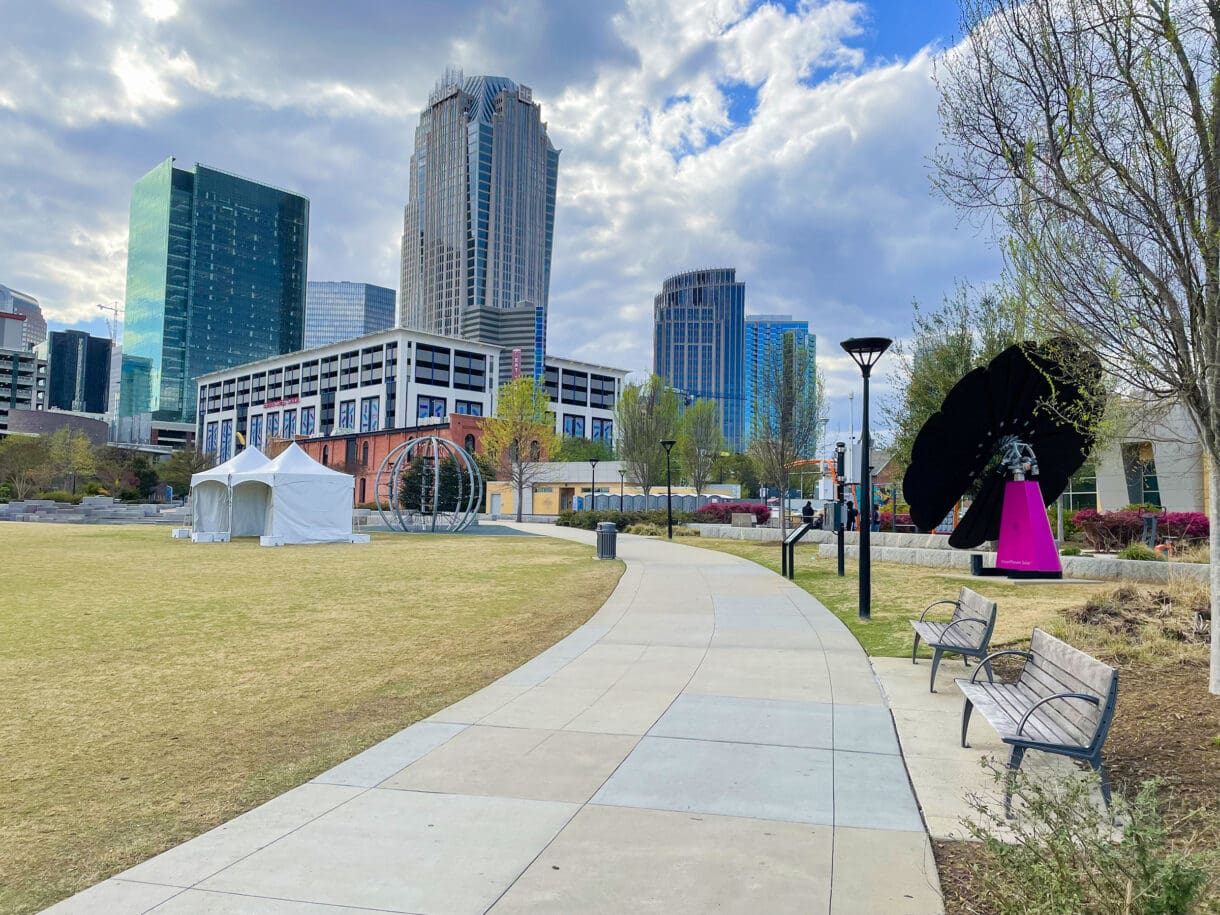 A picture of the Charlotte, NC skyline taken from the sidewalk in a nearby park.
