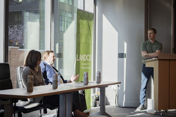 People talking to a moderator at a conference event.