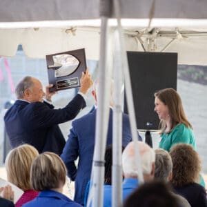 A man shows a woman a photo of the Chatham Park YMCA