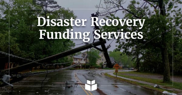 An image of a downed power line stretching across a wet road.