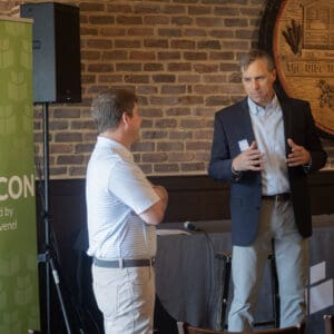Two people conversing at a conference event.