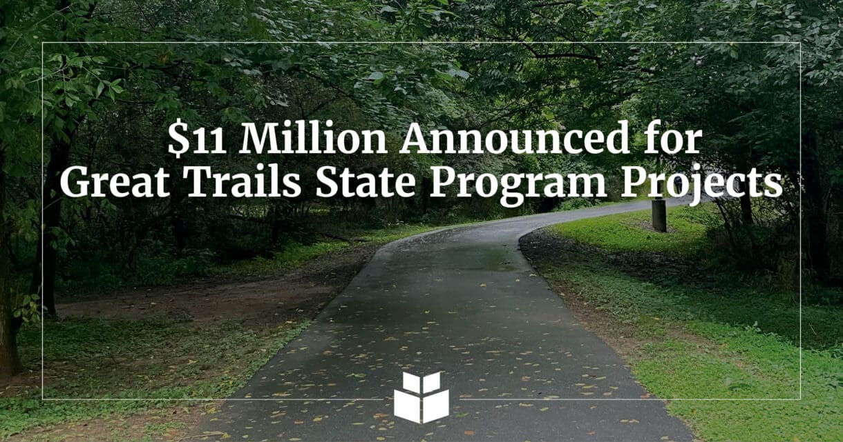 An image of a trail with overlaying text notifying readers of the Great Trails State Program awards.