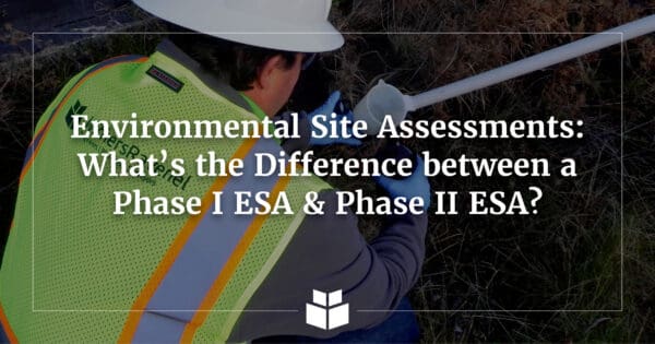 An environmental professional in a safety vest and hard hat in the field collecting an environmental sample