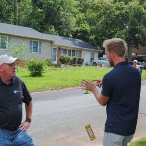 A conversation between two people at a PressurePave demonstration