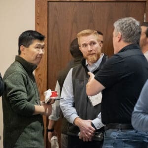 People conversing at the 2025 LandCon Raleigh event.