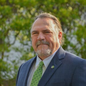 A man with a goatee in a suit and tie