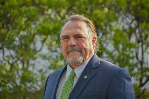 A man with a goatee in a suit and tie