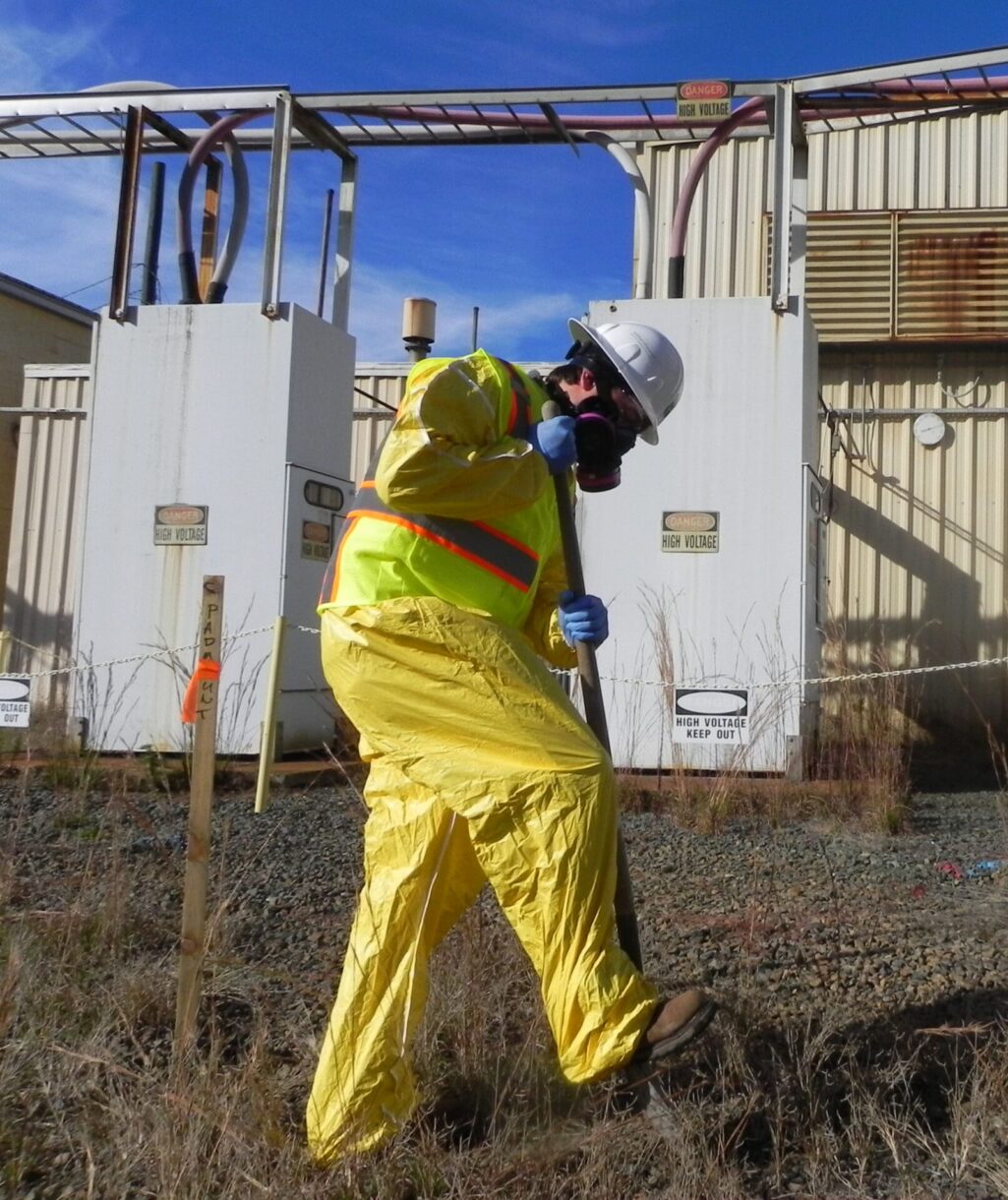 A WithersRavenel Environmental professional in a hazmat suit testing soil.