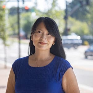 A headshot of a WithersRavenel employee standing in front of a brick column.