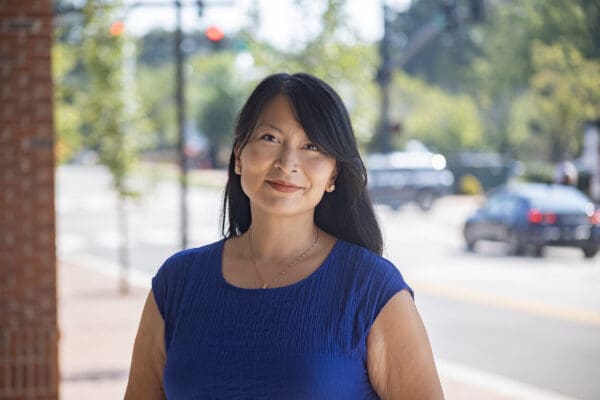 A headshot of a WithersRavenel employee standing in front of a brick column.