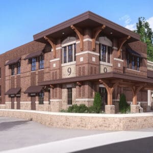 Architectural rendering of the station’s brick side facade and covered corner entrance, with stone retaining walls, a flagpole, and a curved drive.