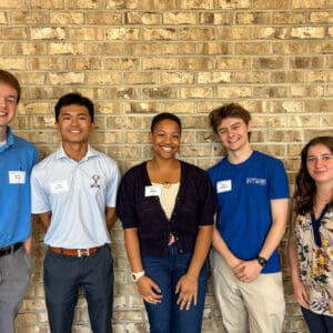 A group of interns gathered at a ceremony.