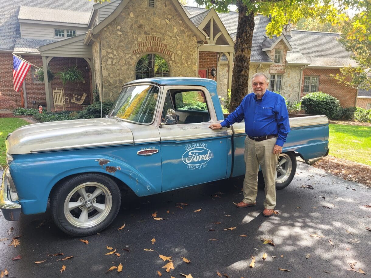 W.T. Sorrell stands beside his blue and silver 1966 Ford F100 truck.