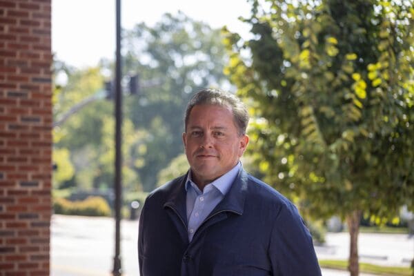 a portrait of André Mullins and his title, Director of Stormwater.